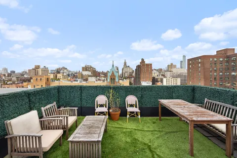 a view of a roof deck with furniture