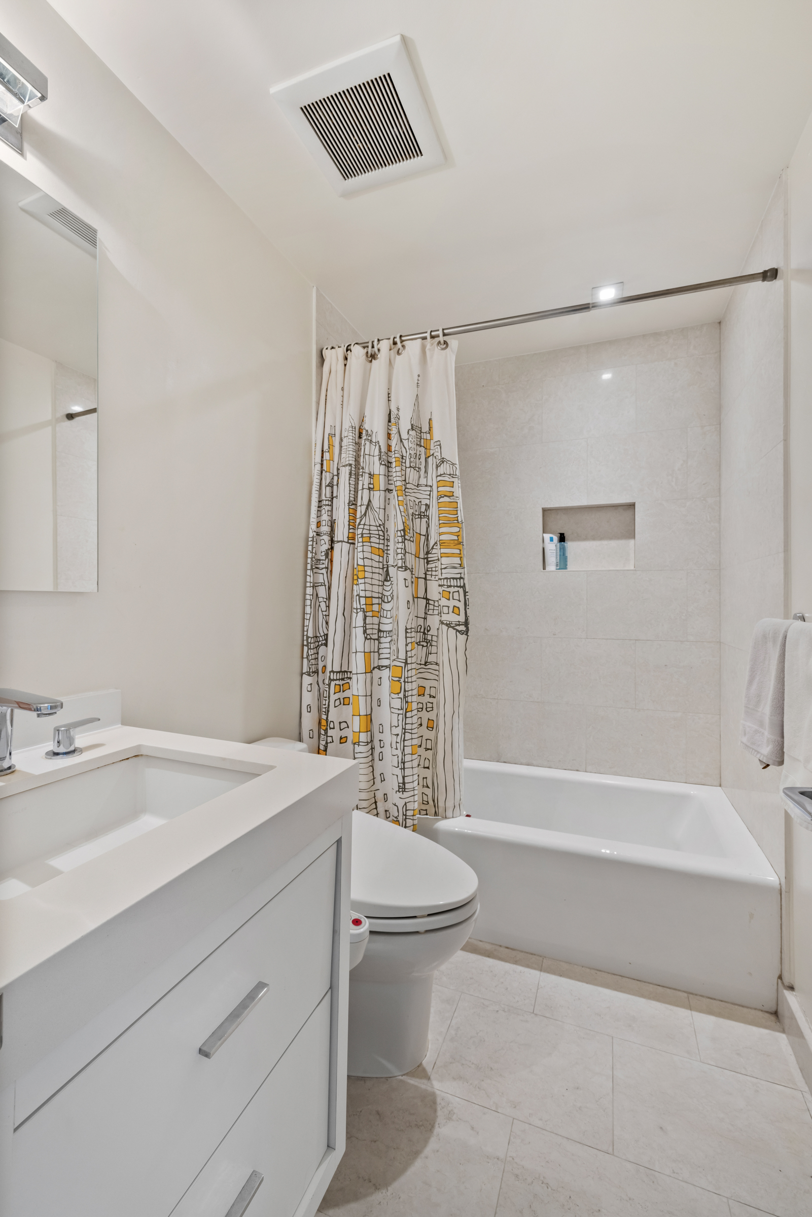 61 West 62nd Street, Unit 23G Manhattan, NY 10023 - Photo 8 of 9 a bathroom with a sink a toilet and a bathtub