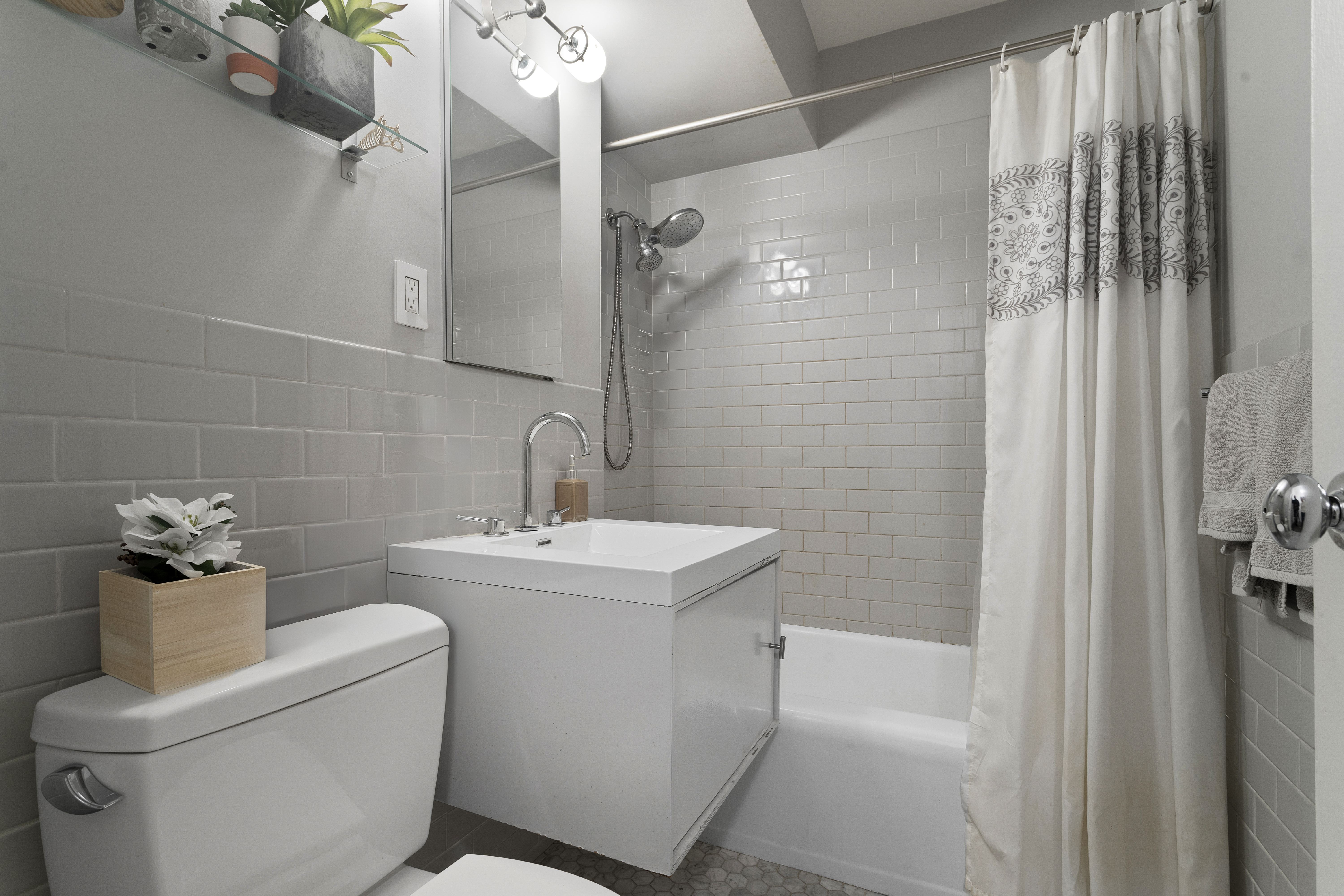 357 East 57th Street, Unit 2E Manhattan, NY 10022 - Photo 9 of 15 a bathroom with a sink toilet and shower