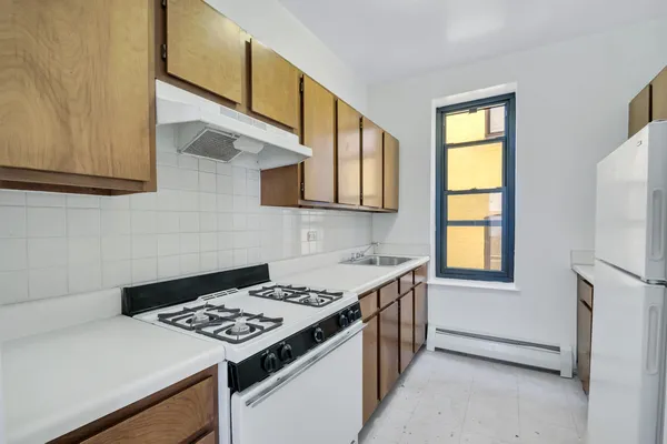 a kitchen that has a stove and a table in it