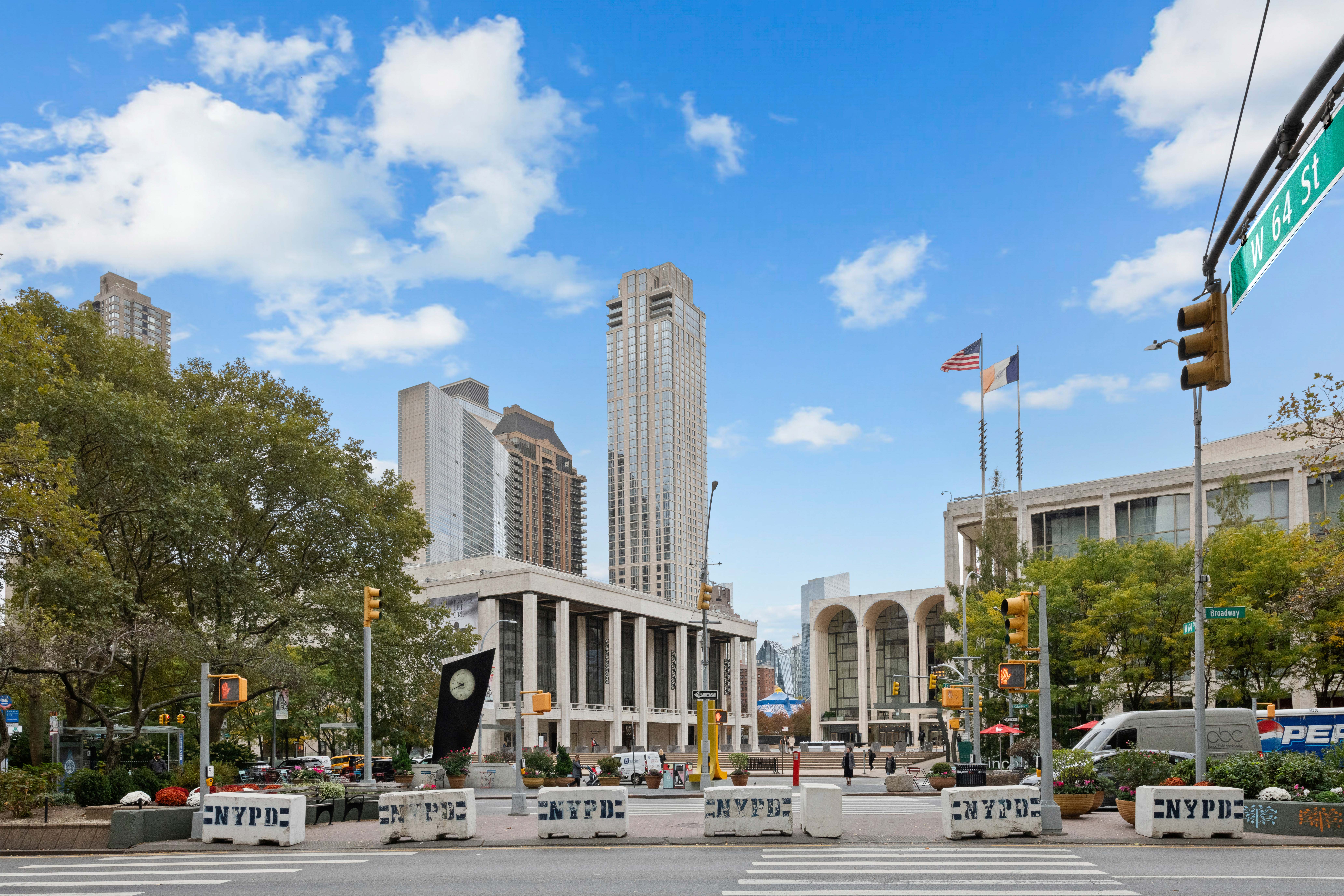17 West 64th Street, Unit 4E Manhattan, NY 10023 - Photo 8 of 9 a city street lined with buildings and trees
