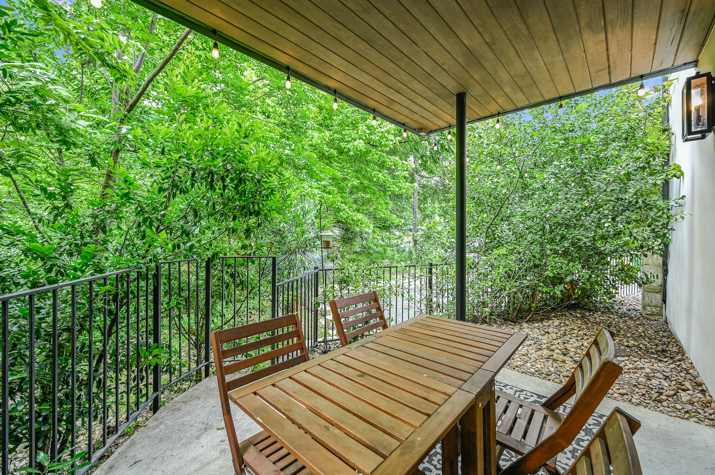 500 South 3rd Street, Unit A Austin, TX 78704 - Photo 18 of 24 a view of a patio with table and chairs with wooden floor and fence