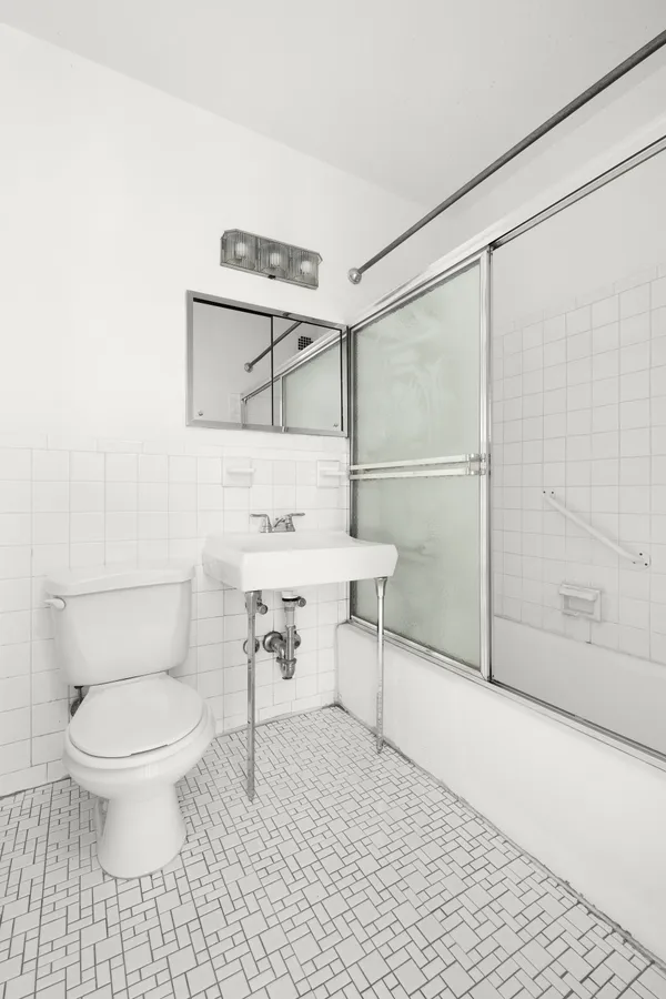 a bathroom with a toilet a sink and shower