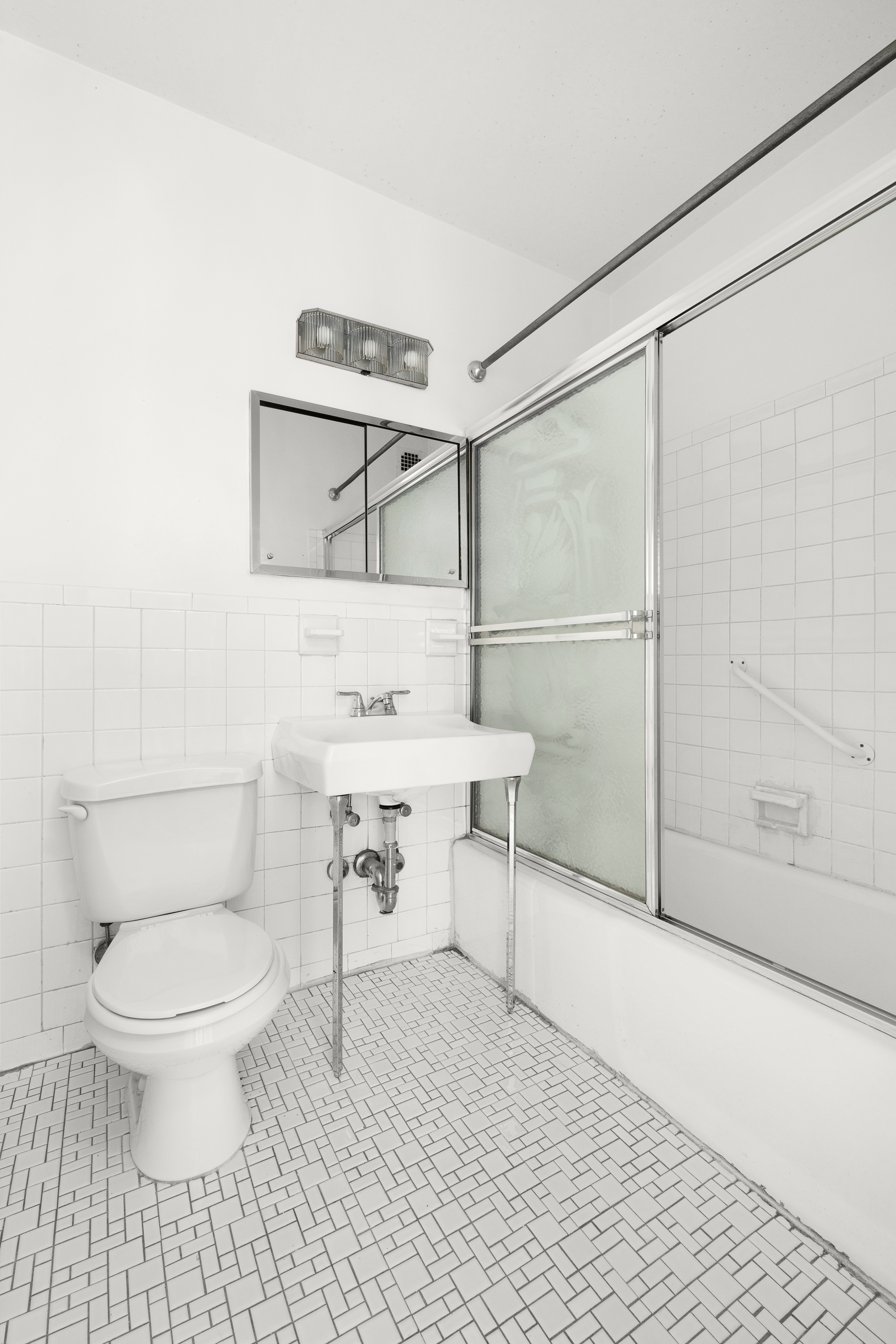 300 East 74th Street, Unit 20E Manhattan, NY 10021 - Photo 7 of 14 a bathroom with a toilet a sink and shower