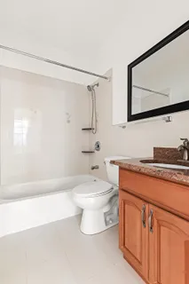 a bathroom with a toilet a sink and bathtub