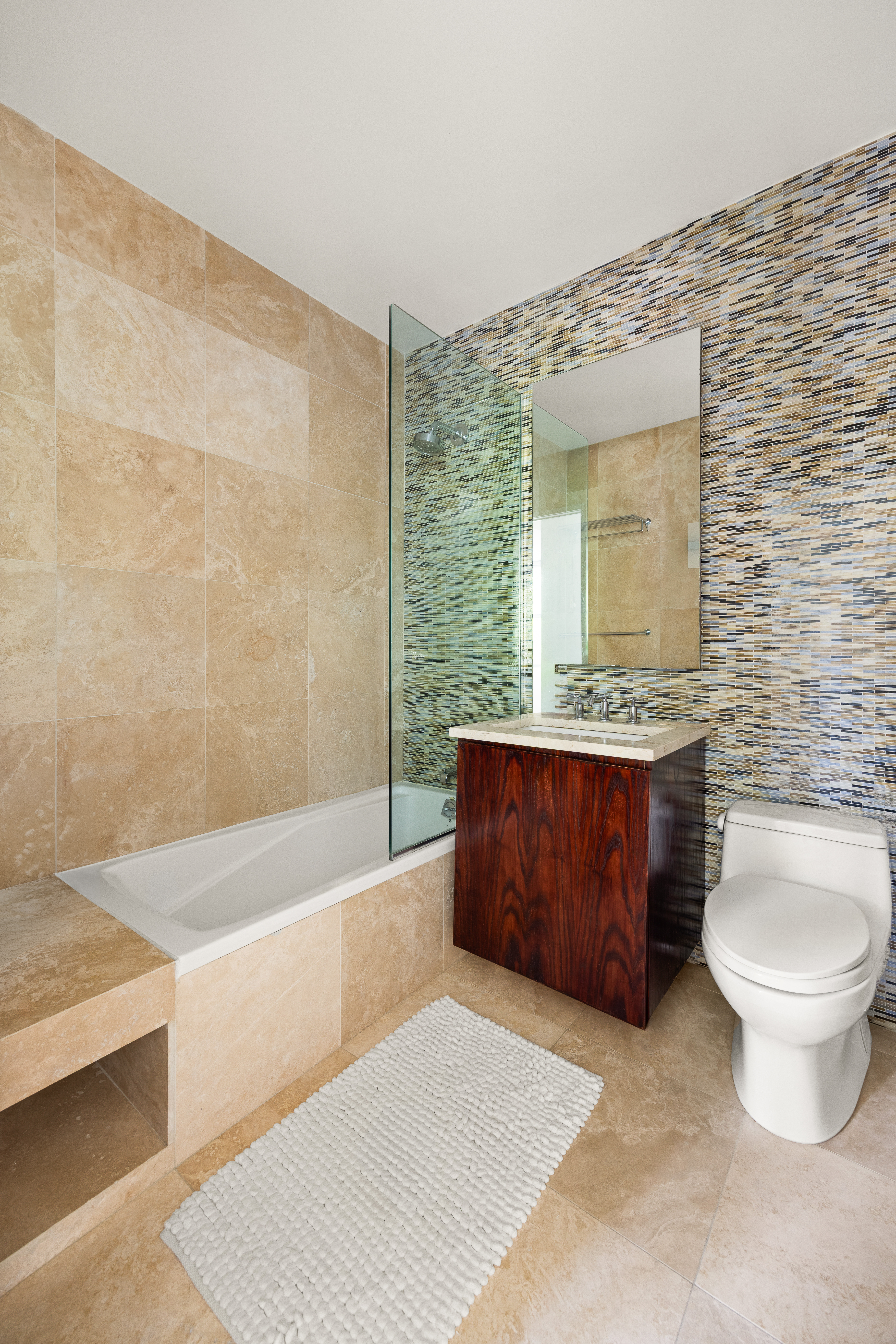 344 West 23rd Street, Unit 2B Manhattan, NY 10011 - Photo 6 of 10 a bathroom with a granite countertop toilet sink and mirror