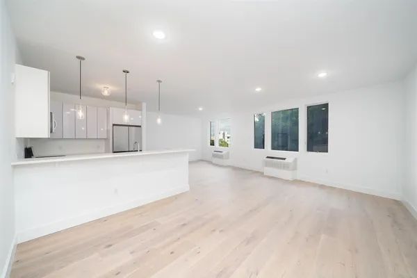 a view of an empty room with kitchen appliances