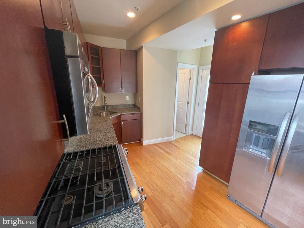 1033 Park Road Northwest, Unit 6 Washington, DC 20010 - Photo 5 of 38 a kitchen with granite countertop a refrigerator and a stove