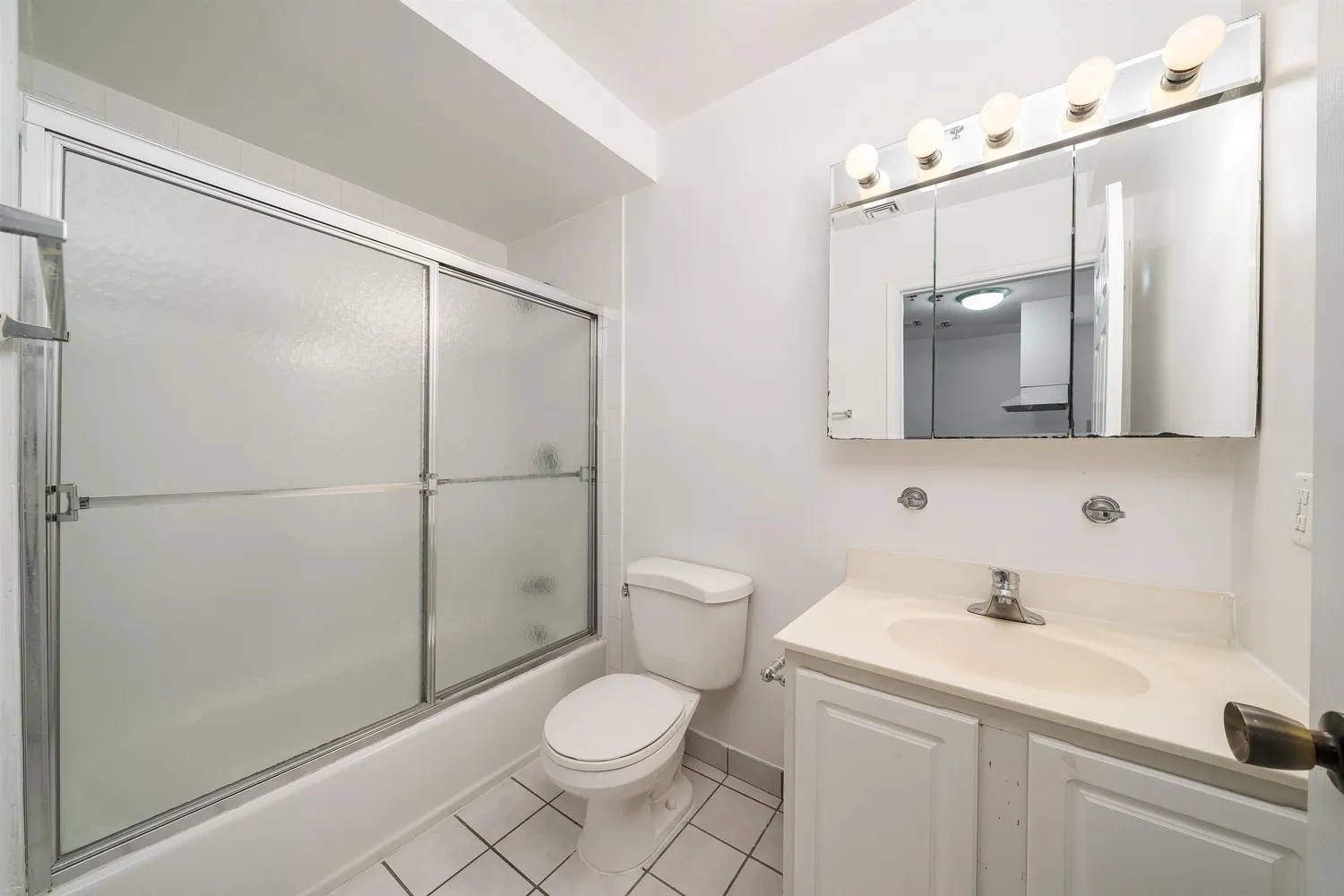 a bathroom with a toilet a sink and shower