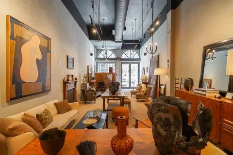 a living room with furniture fireplace and a large window