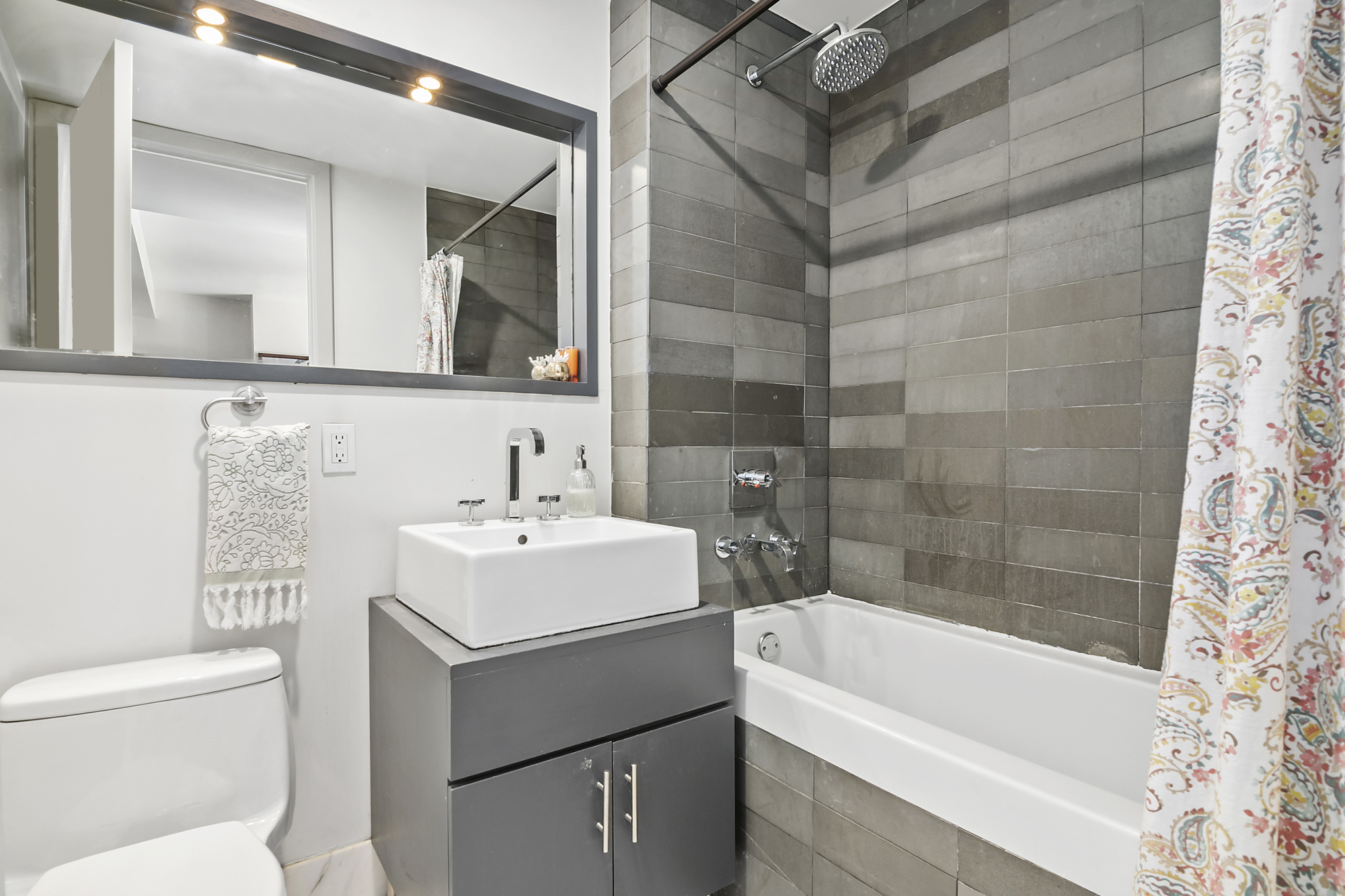 84 Front Street, Unit 7F Brooklyn, NY 11201 - Photo 7 of 12 a bathroom with a sink a toilet and a bathtub