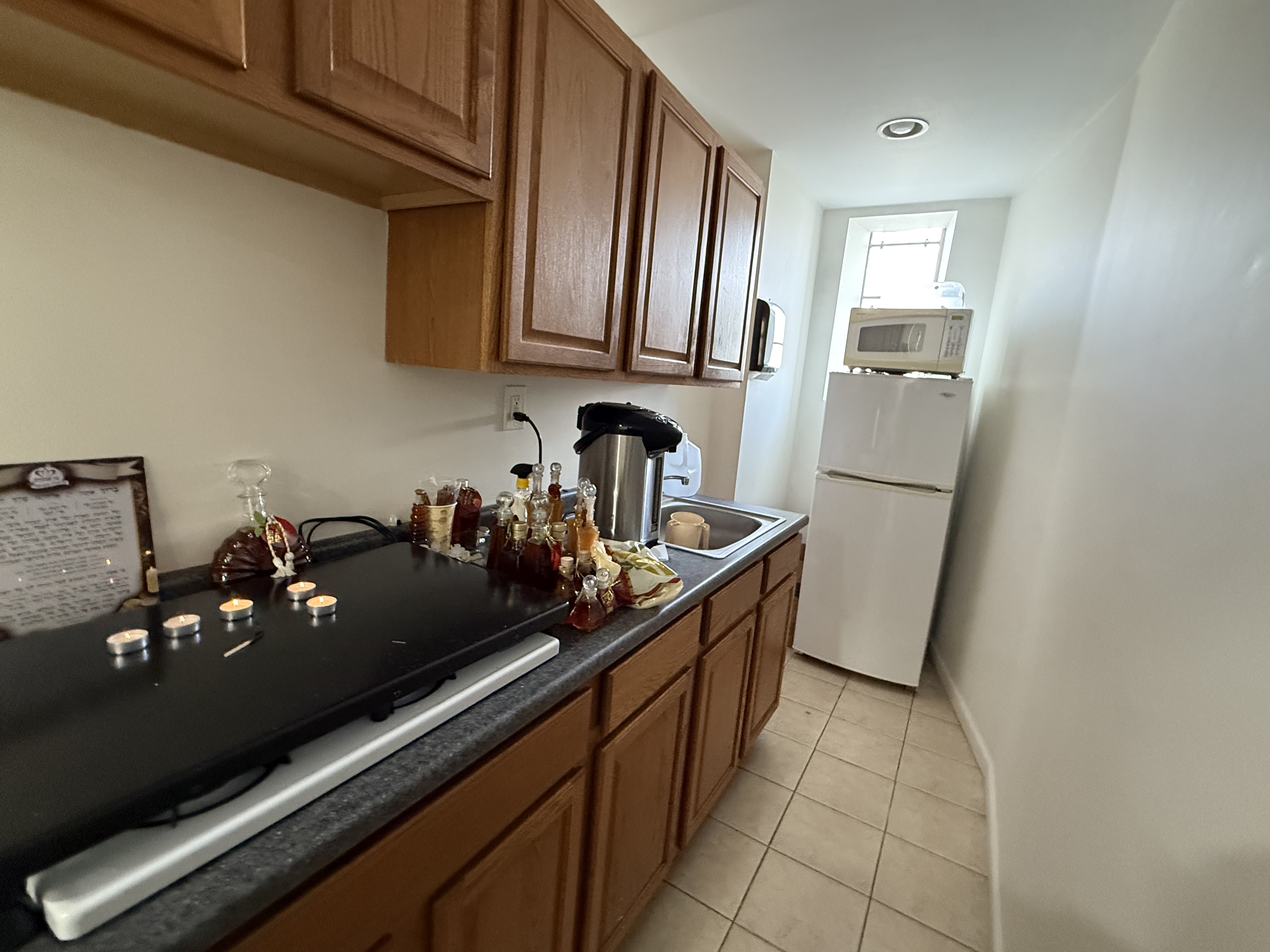 599 60th Street West New York, NJ 07093 - Photo 12 of 17 a kitchen with granite countertop a refrigerator stove and sink