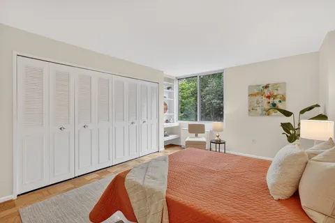 a bedroom with a bed and a lamp on table