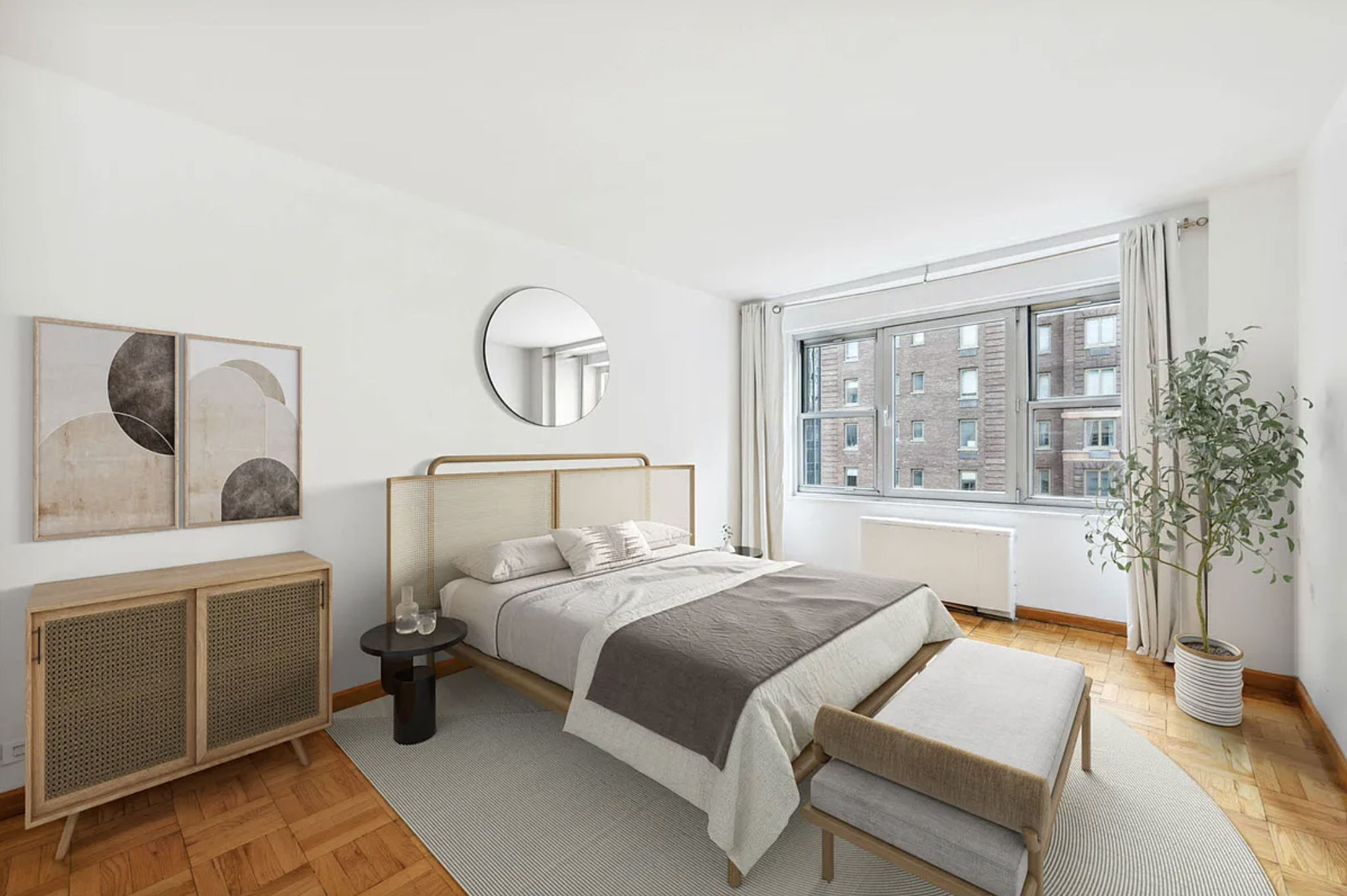 77 West 55th Street, Unit 11G Manhattan, NY 10019 - Photo 4 of 12 a bedroom with a large bed and a chandelier