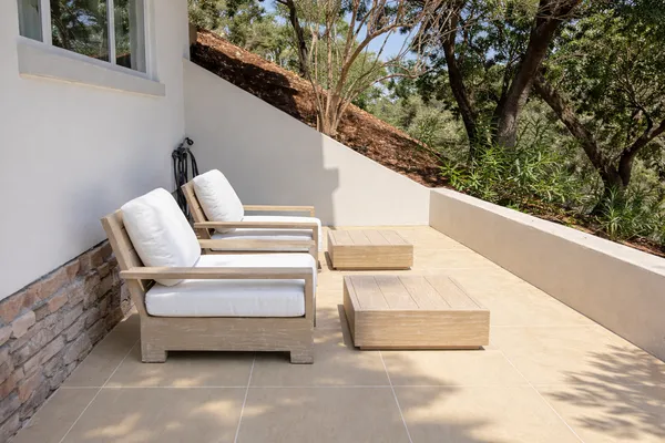 a view of a backyard with table and chairs under an umbrella