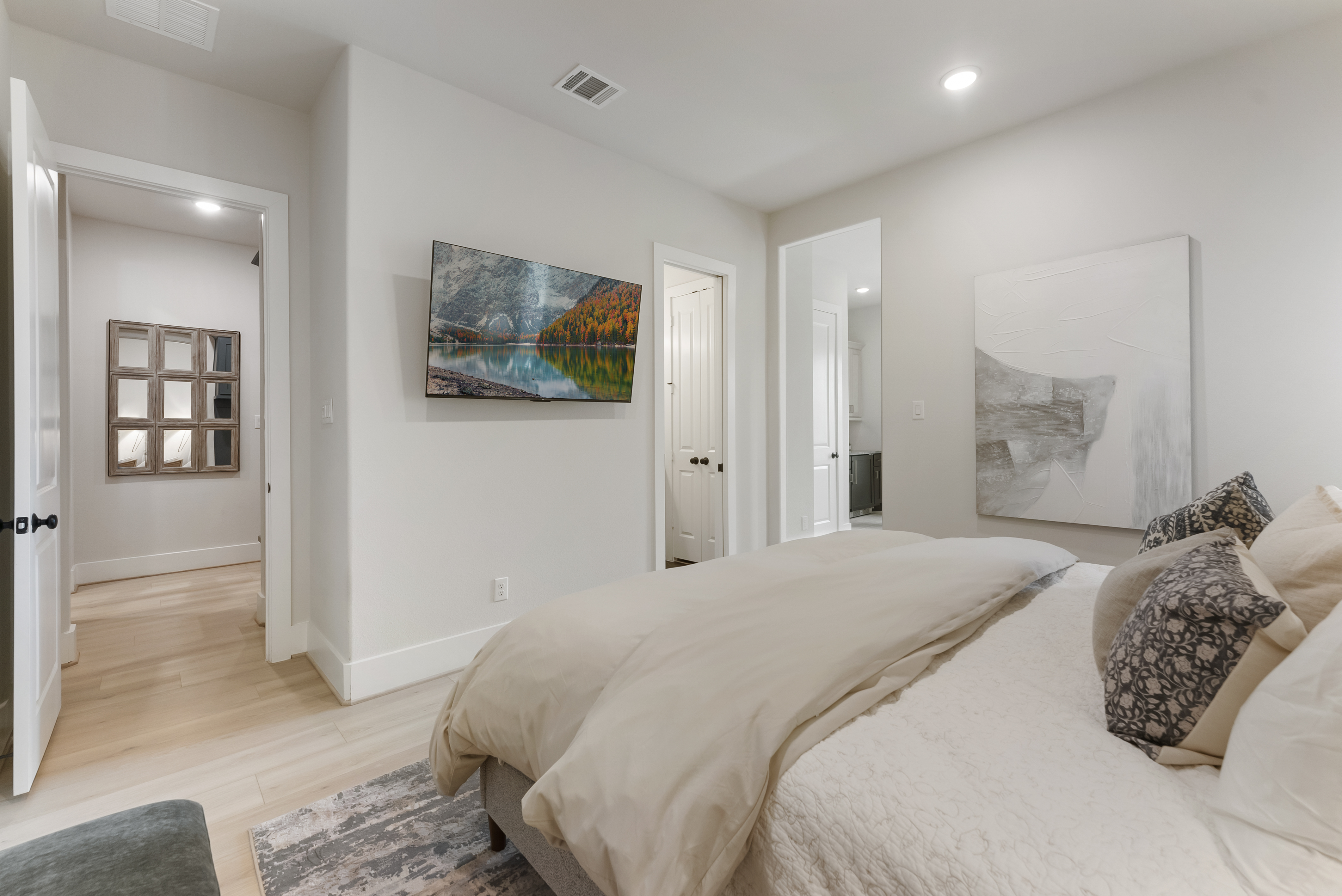 2118 Bennet Court Conroe, TX 77384 - Photo 48 of 70 a bedroom with a large bed and a painting on the wall