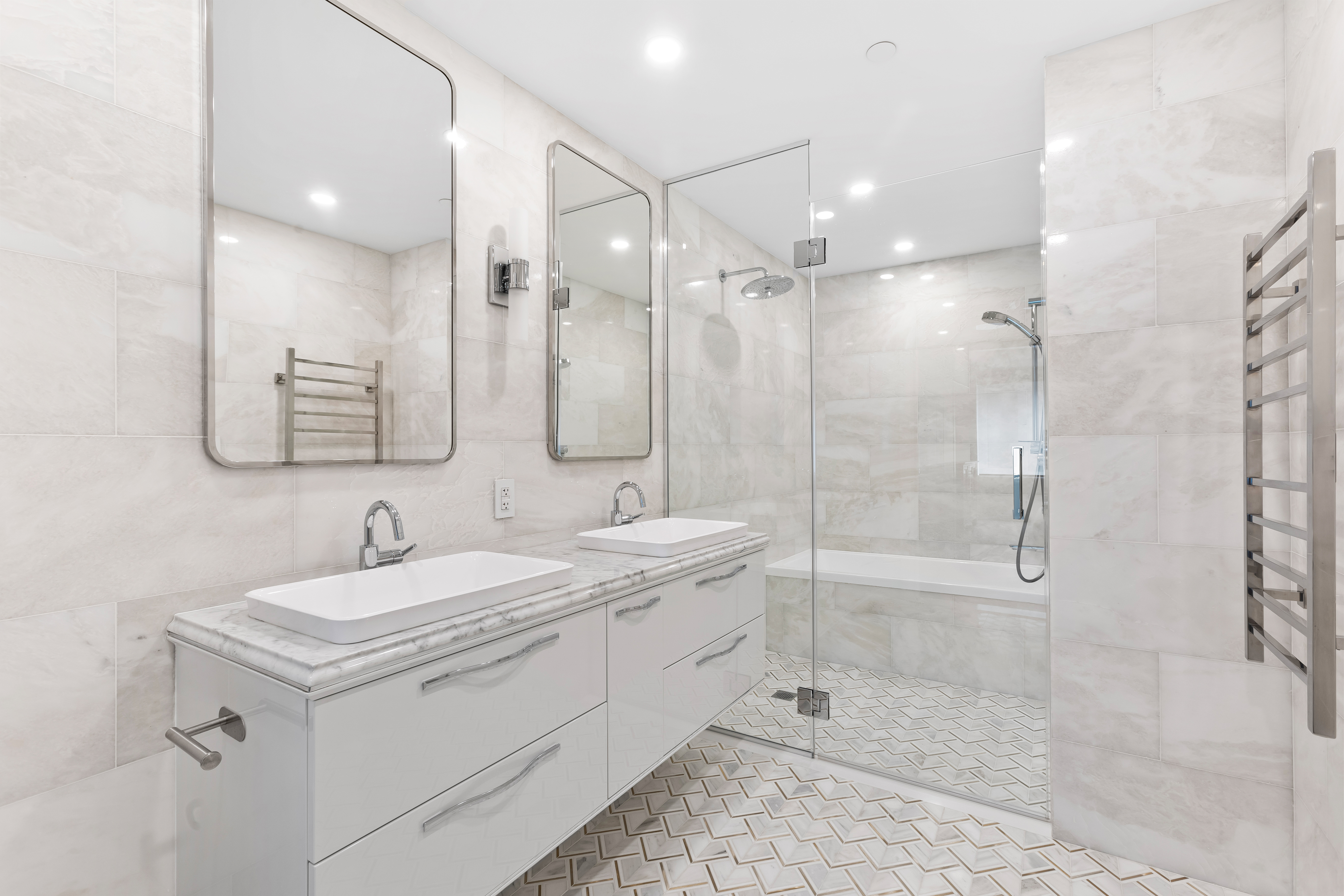 126 East 86th Street, Unit 5B Manhattan, NY 10028 - Photo 6 of 22 a bathroom with a double vanity sink mirror double and shower