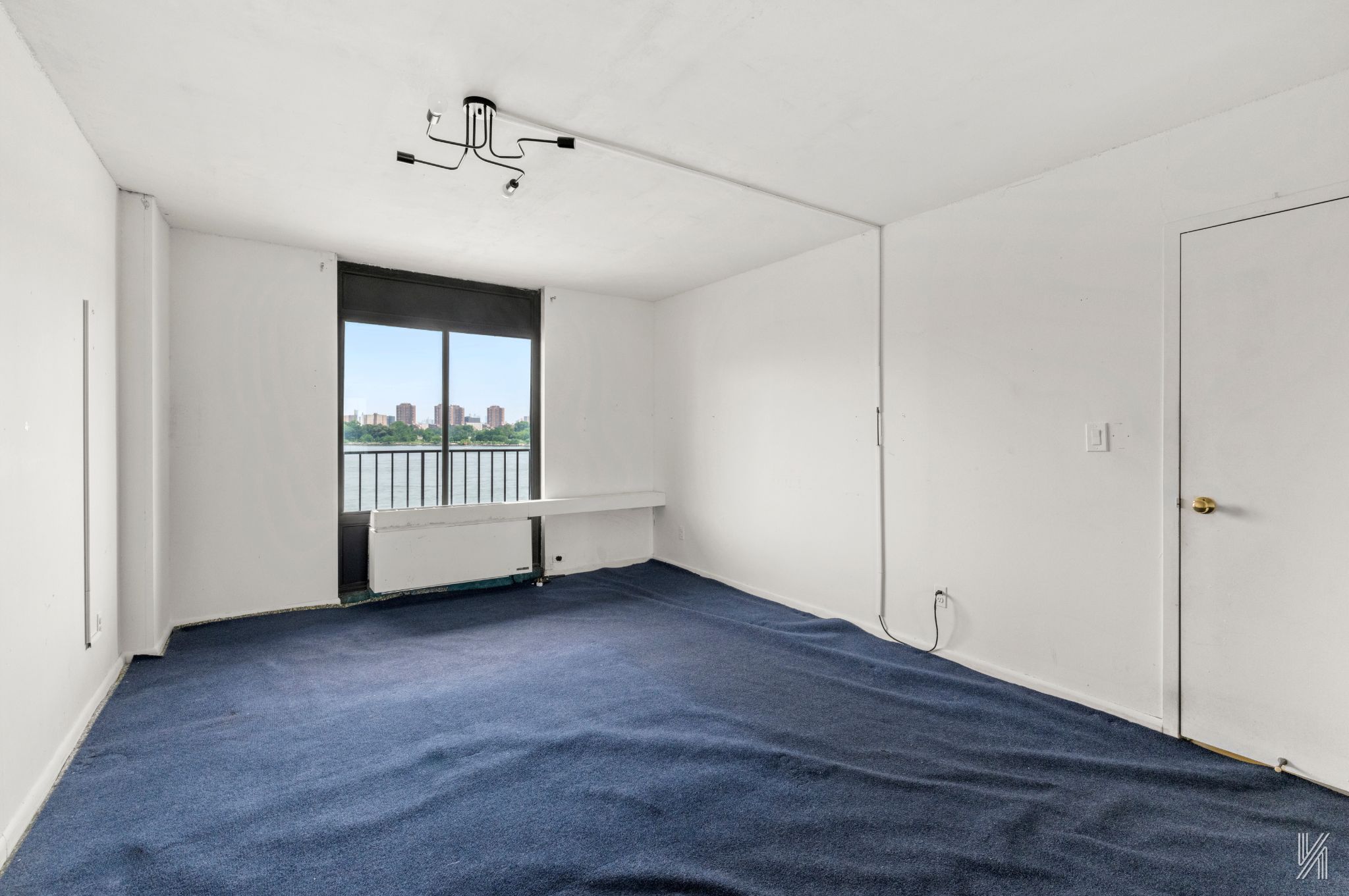 25-40 Shore Boulevard, Unit 4R Queens, NY 11102 - Photo 6 of 11 a view of an empty room with a window