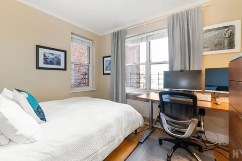 a bedroom with a bed and a desk