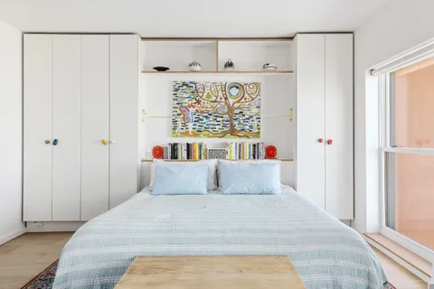 a bedroom with a bed and a window