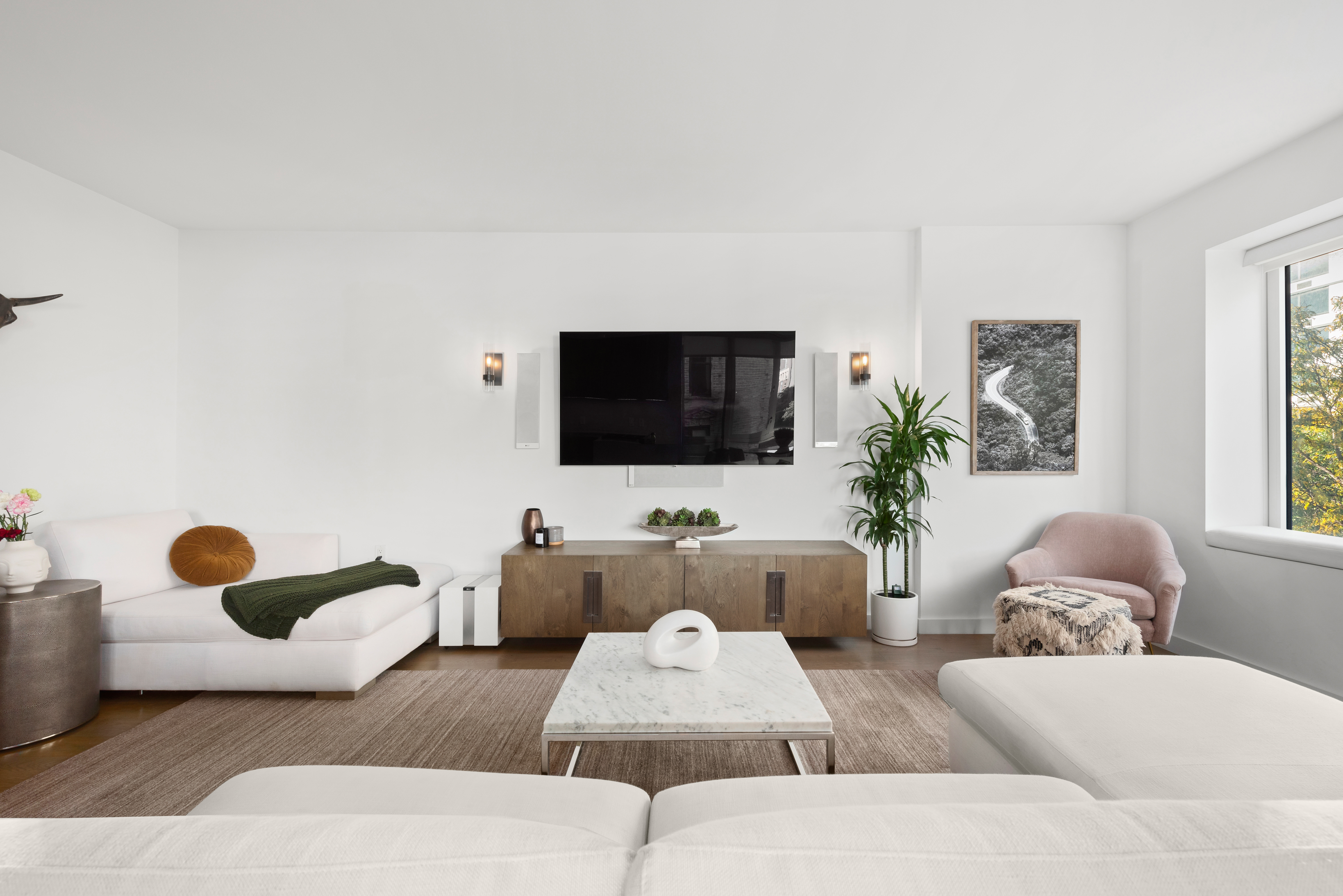 265 East Houston Street, Unit 4 Manhattan, NY 10002 - Photo 2 of 20 a living room with furniture and a flat screen tv