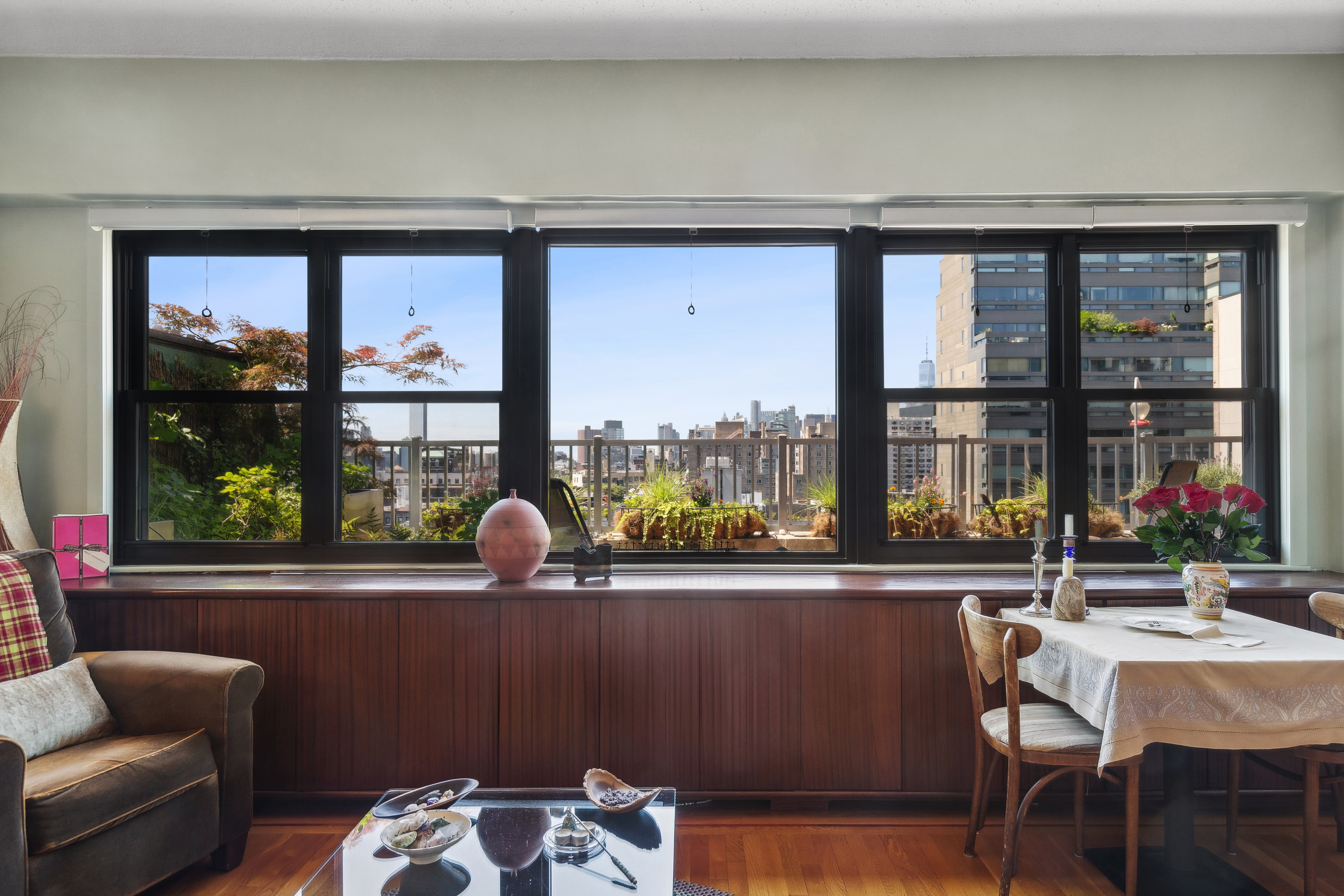 210 East 15th Street, Unit PHD Manhattan, NY 10003 - Photo 2 of 12 a dining room with furniture and window
