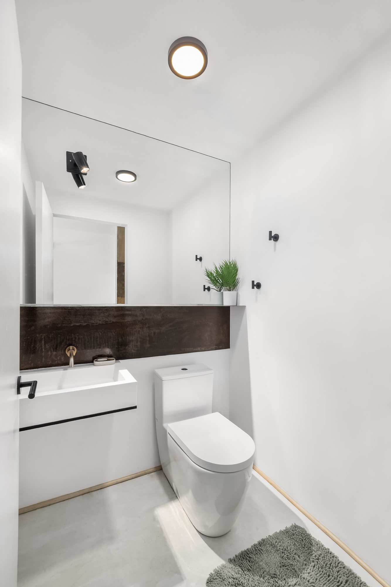 126 South 2nd Street, Unit GARDEN Brooklyn, NY 11249 - Photo 22 of 30 a bathroom with a sink a toilet and a mirror