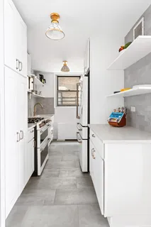 a kitchen with a refrigerator and a stove