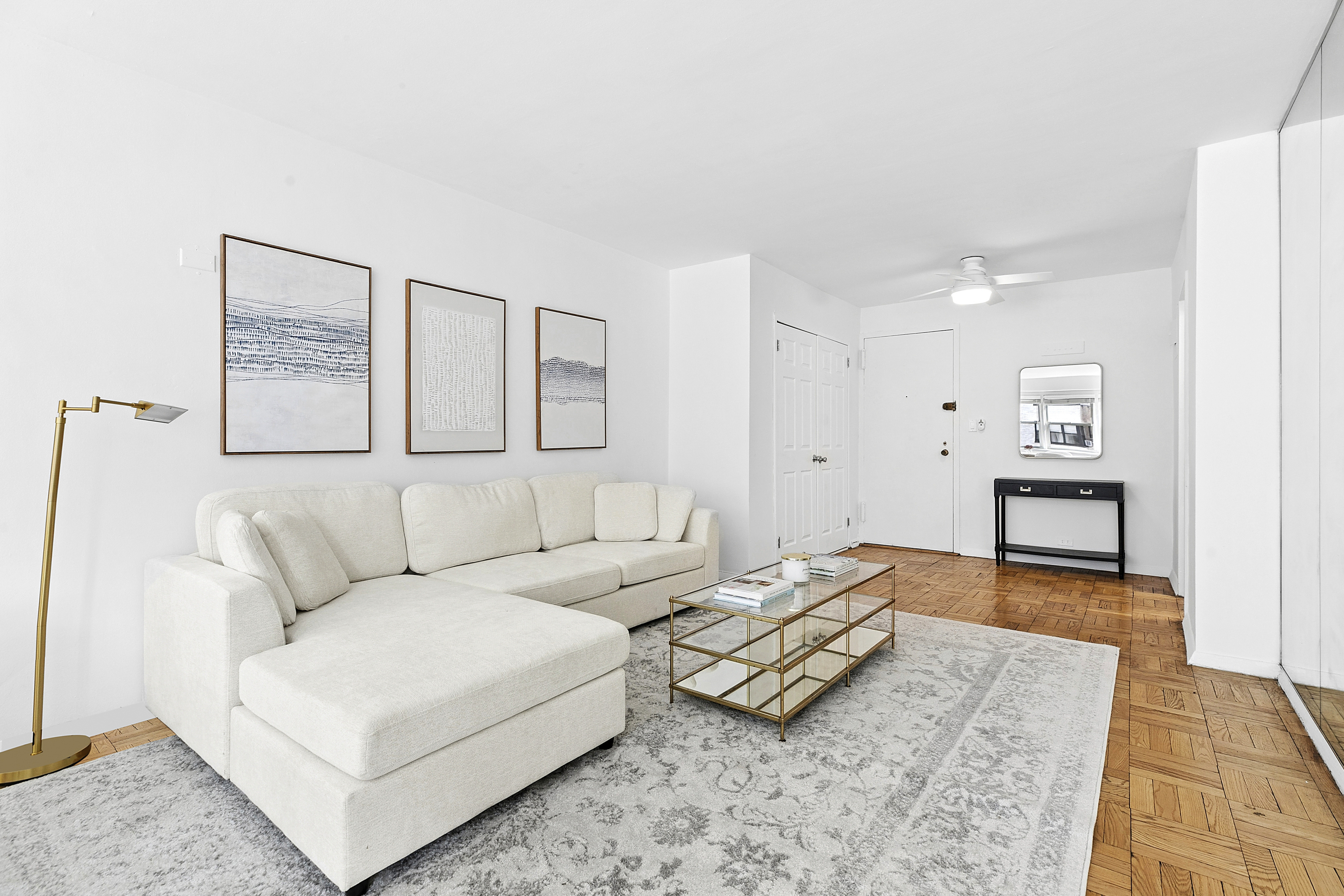 411 East 57th Street, Unit 14F Manhattan, NY 10022 - Photo 2 of 8 a living room with furniture and a rug