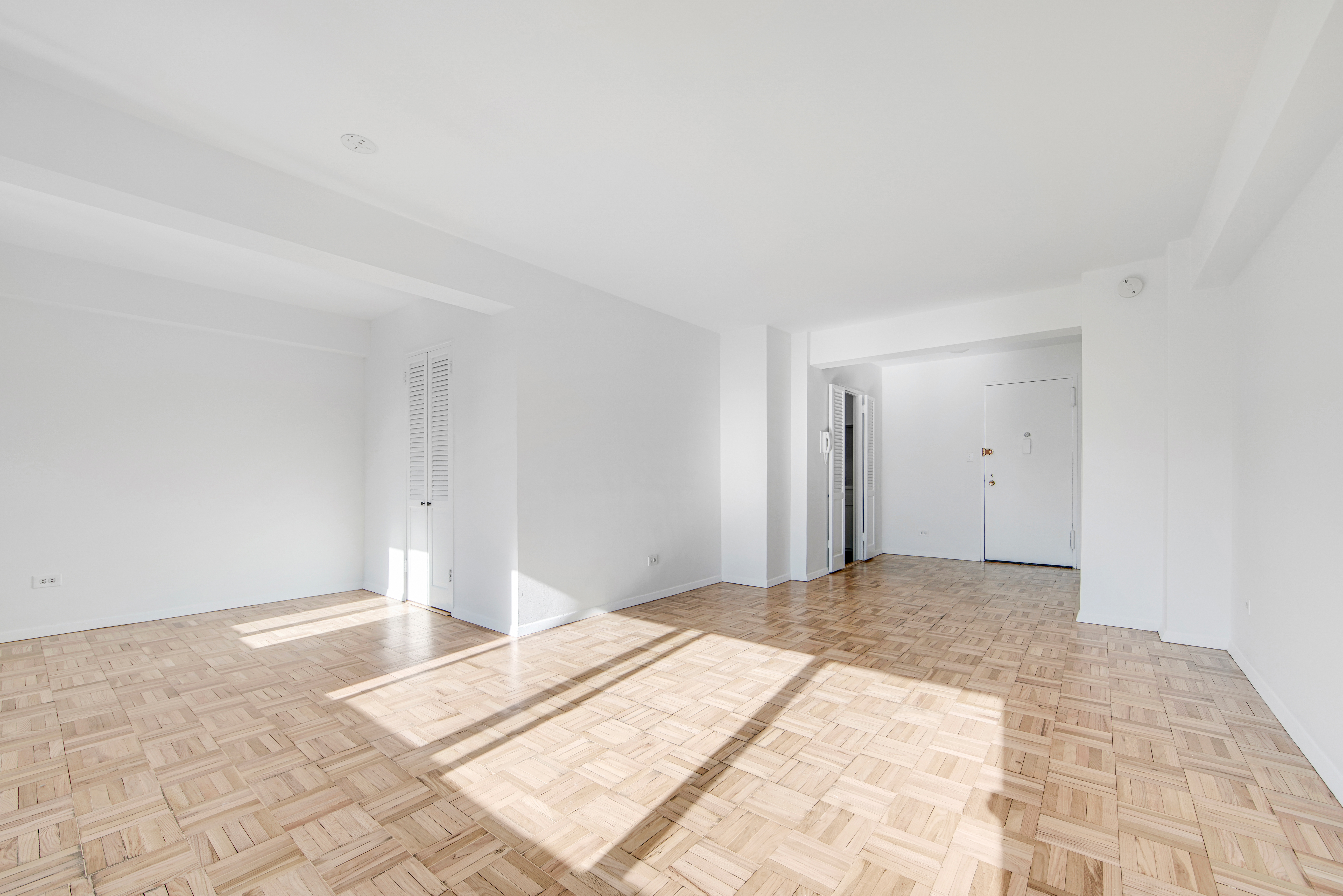 401 East 65th Street, Unit 10H Manhattan, NY 10065 - Photo 8 of 14 a view of a big room with wooden floor and cabinet