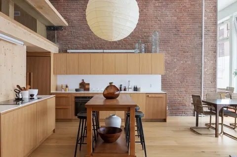 a kitchen with a table chairs sink and cabinets