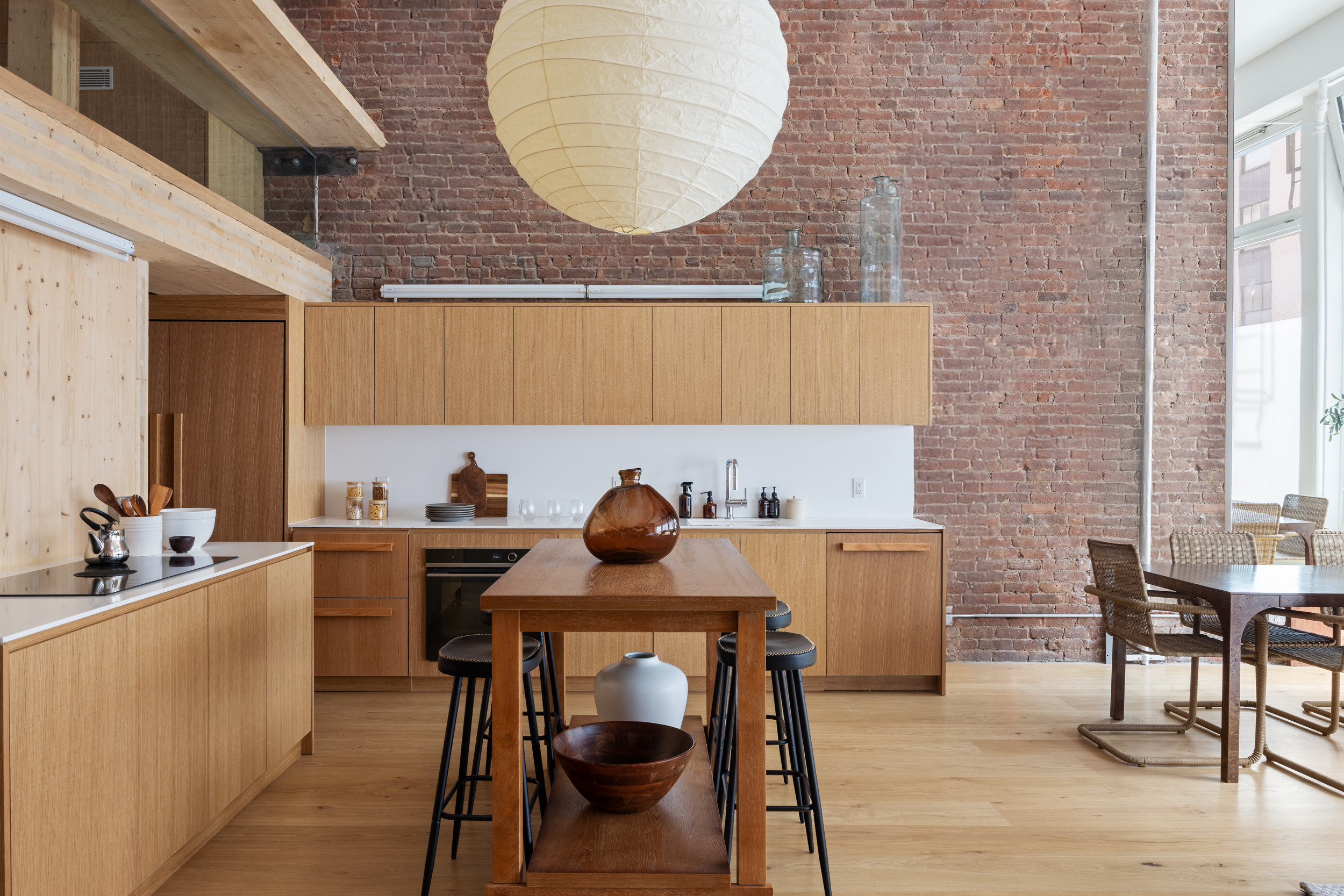 74 Reade Street, Unit 1EAST Manhattan, NY 10007 - Photo 4 of 22 a kitchen with a table chairs sink and cabinets