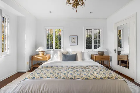 a bedroom with bed and wooden floor