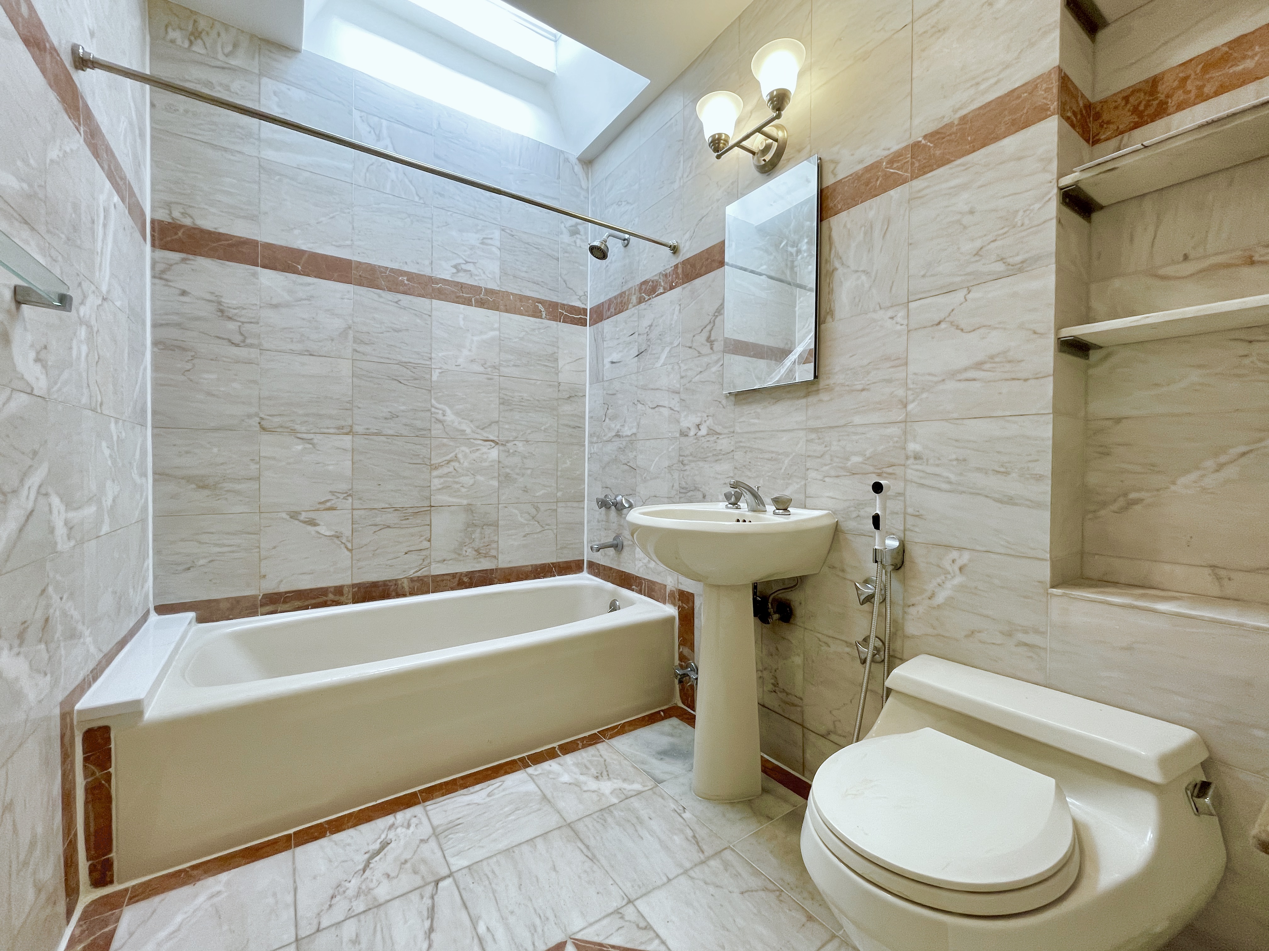 144 96th Street Brooklyn, NY 11209 - Photo 4 of 9 a bathroom with a sink a toilet and bathtub