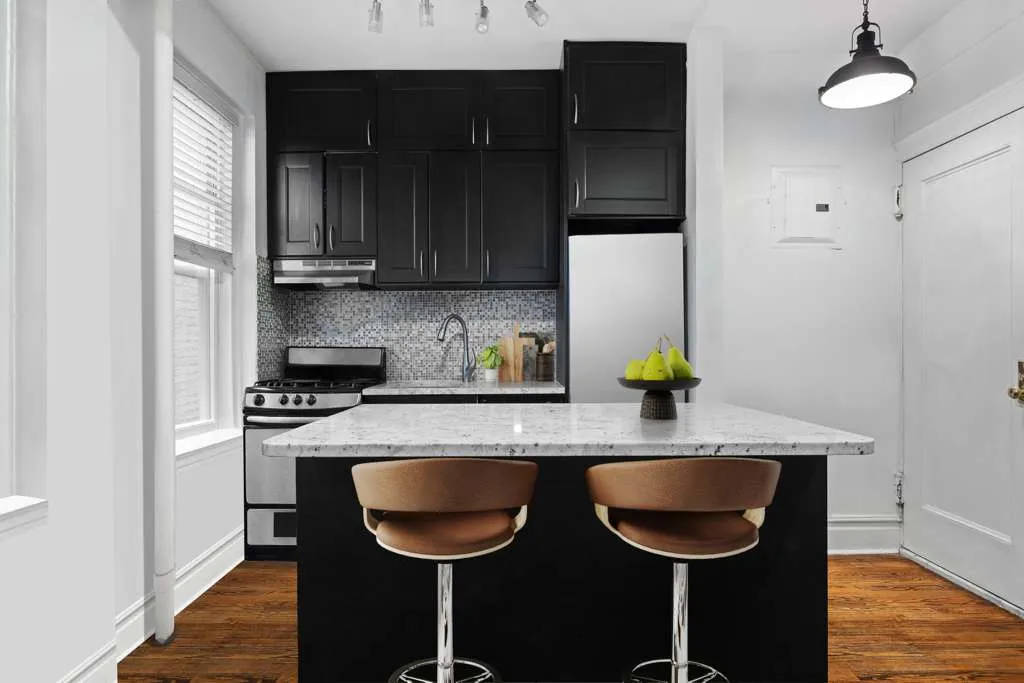 a kitchen with stainless steel appliances a sink cabinets and wooden floor