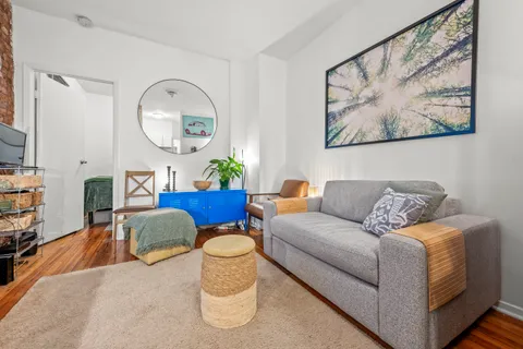 a living room with furniture and a mirror