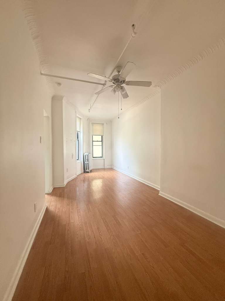 313 Van Buren Street Brooklyn, NY 11221 - Photo 11 of 20 wooden floor in an empty room