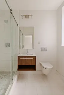 a bathroom with a double vanity sink mirror and toilet