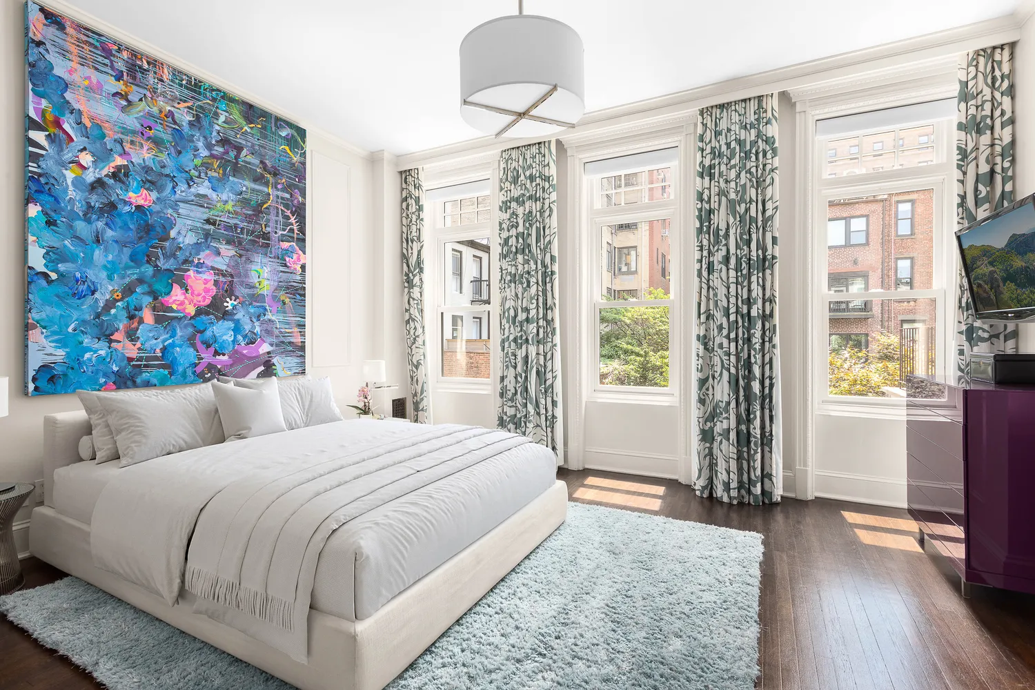 a bedroom with a large bed and a window