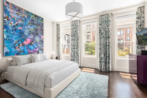 a bedroom with a large bed and a window