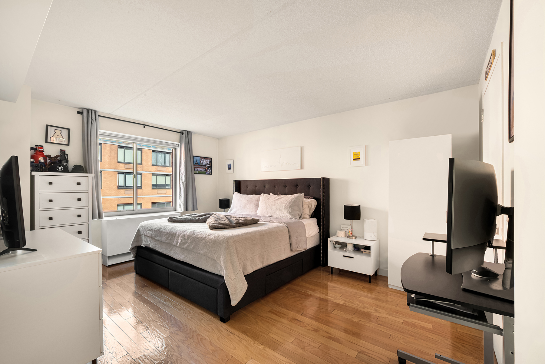 555 West 23rd Street, Unit S11C Manhattan, NY 10011 - Photo 3 of 12 a bedroom with a bed and a flat screen tv