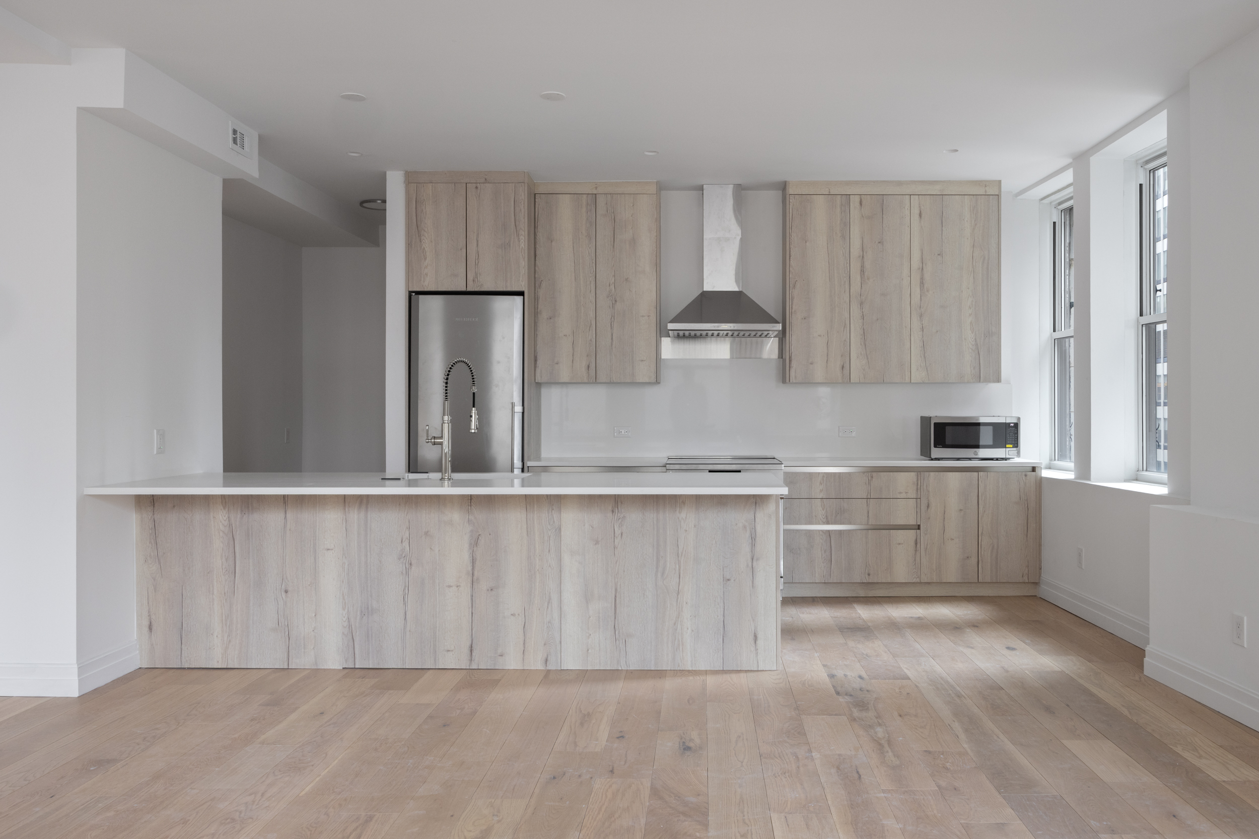 55 Liberty Street, Unit 12C Manhattan, NY 10005 - Photo 4 of 10 a kitchen with a cabinets and window