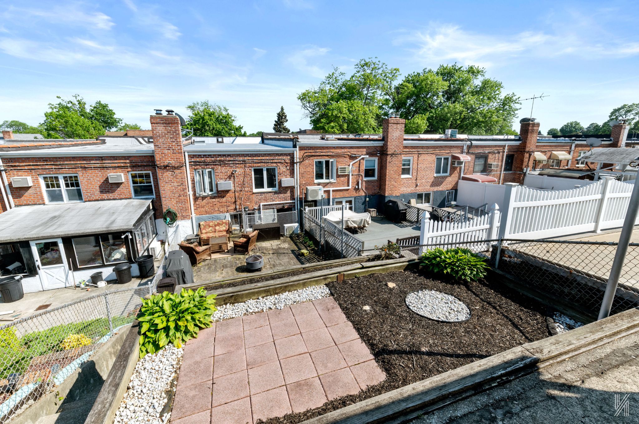 67-17 Eliot Avenue Queens, NY 11379 - Photo 19 of 21 a view of a patio with couches table and chairs with wooden fence