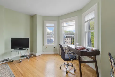 a workspace with furniture and a flat screen tv
