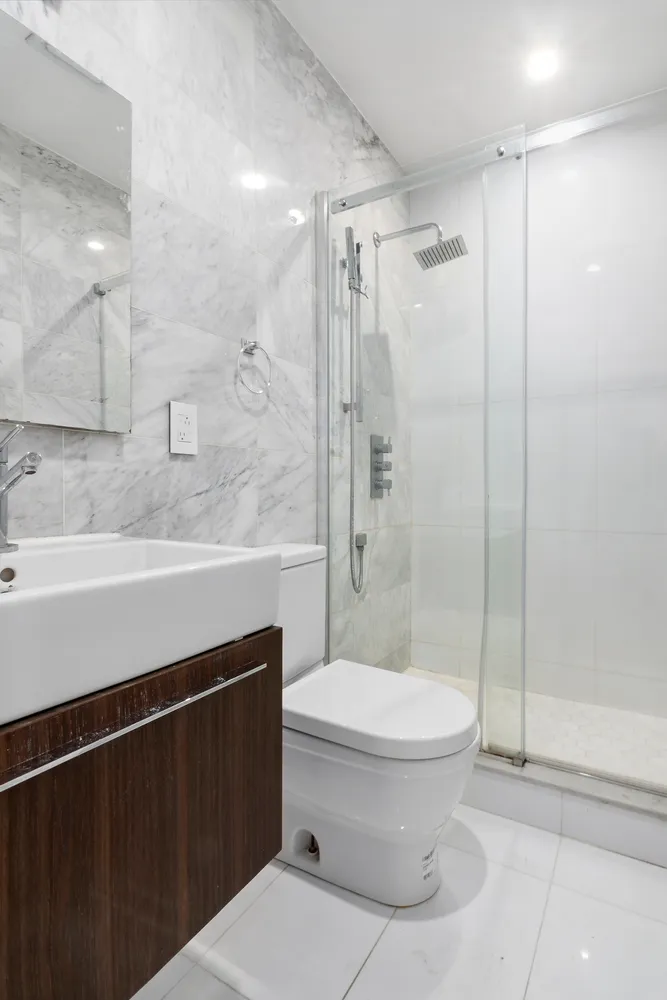 a bathroom with a toilet a sink and shower