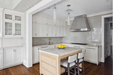 a kitchen with a table chairs and a stove