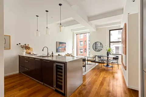 a view of a kitchen center island and stainless steel appliances