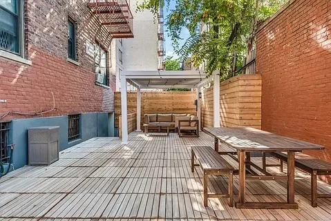 a view of a patio with table and chairs and potted plants