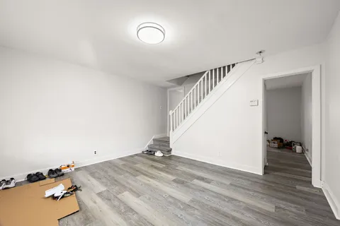a view of a room with wooden floor and stairs