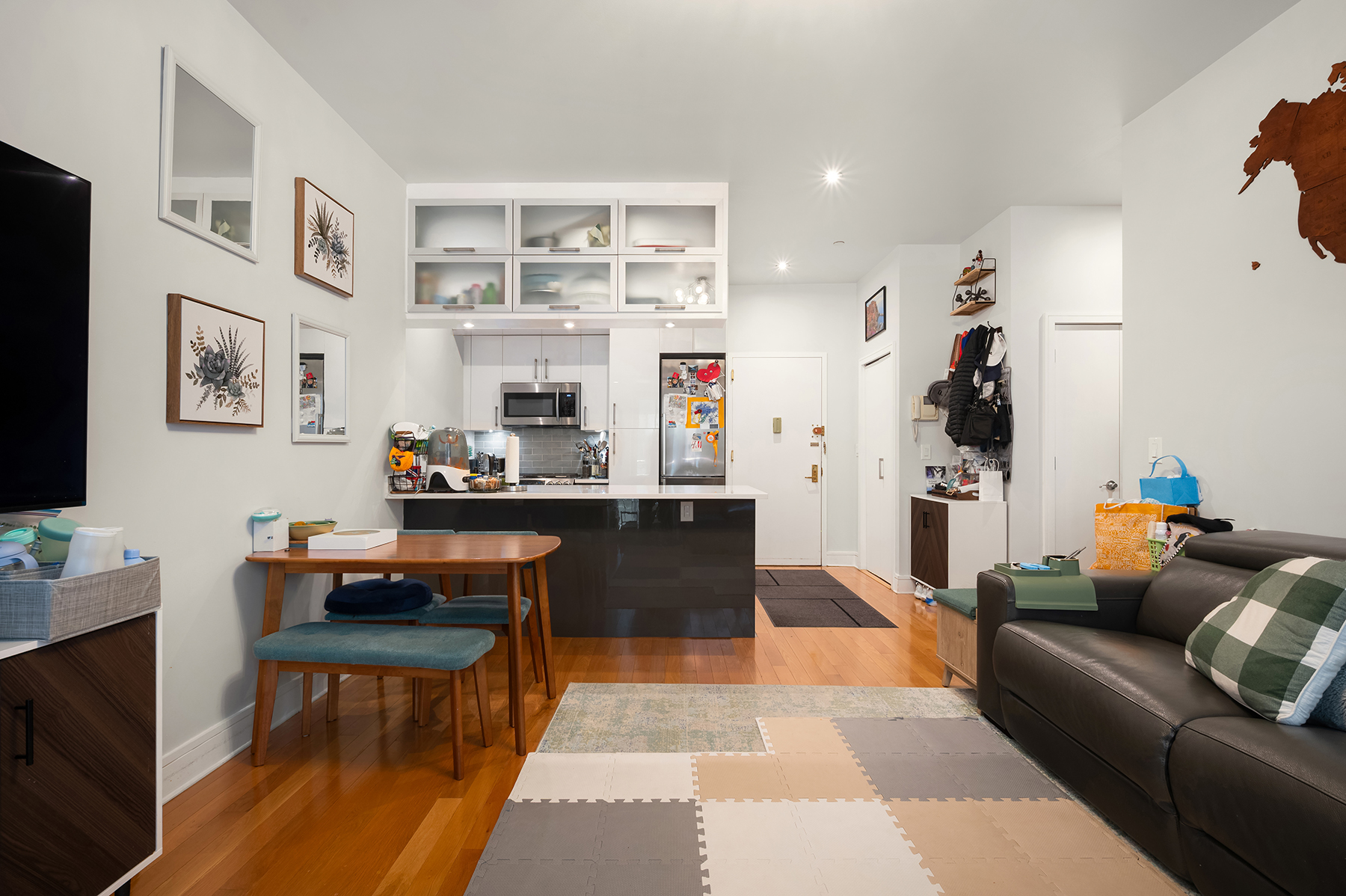 41-26 27th Street, Unit 5E Queens, NY 11101 - Photo 3 of 12 a living room with furniture and a fireplace